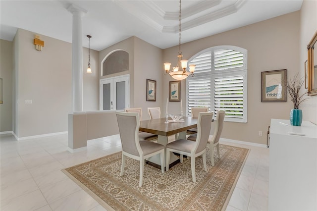 21 Webster Ln, Palm Coast, FL 32164 - dining space with crown molding, ornate columns, a chandelier, a tray ceiling, and baseboards
