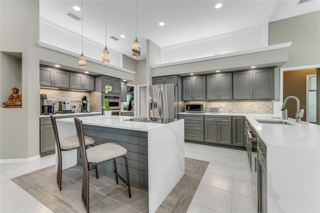 21 Webster Ln, Palm Coast, FL 32164 - kitchen with stainless steel appliances, a sink, gray cabinets, light stone countertops, and recessed lighting