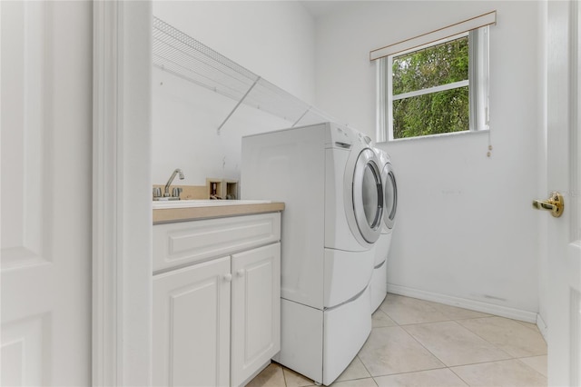 21 Webster Ln, Palm Coast, FL 32164 - washroom with washer and clothes dryer, cabinet space, and light tile patterned flooring