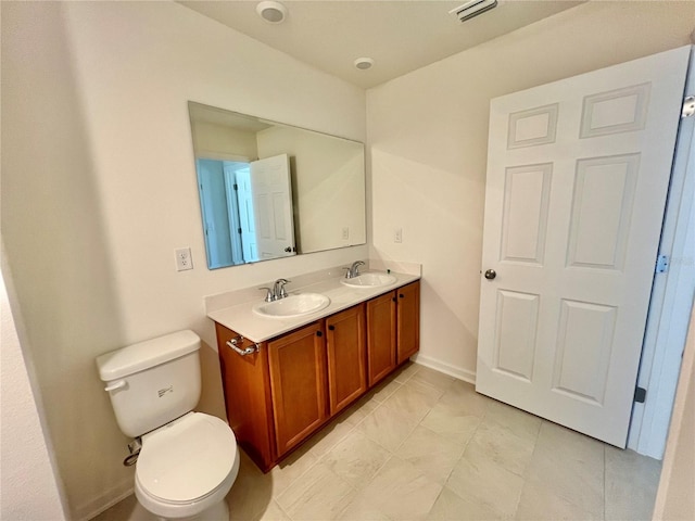60 SW Waverly Ln, Palm Coast, FL 32164 - bathroom featuring double vanity, toilet, and tile patterned floors