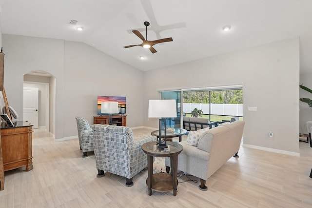 70 Esperanto Dr, Palm Coast, FL 32164 - living area with arched walkways, a ceiling fan, lofted ceiling, baseboards, and light wood-style flooring