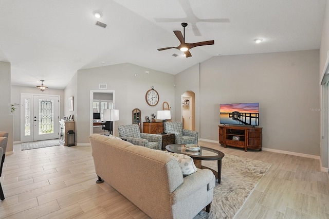 70 Esperanto Dr, Palm Coast, FL 32164 - living area featuring arched walkways, vaulted ceiling, ceiling fan, light wood finished floors, and baseboards