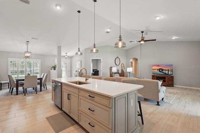 70 Esperanto Dr, Palm Coast, FL 32164 - kitchen with a sink, stainless steel dishwasher, light countertops, light wood finished floors, and an island with sink