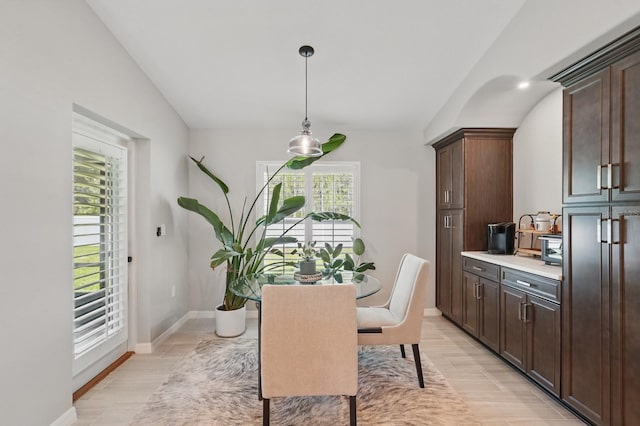 70 Esperanto Dr, Palm Coast, FL 32164 - dining area with lofted ceiling, light wood-style flooring, and baseboards