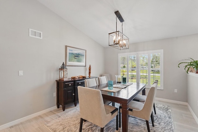 70 Esperanto Dr, Palm Coast, FL 32164 - dining space with a chandelier, baseboards, light wood-style flooring, and vaulted ceiling