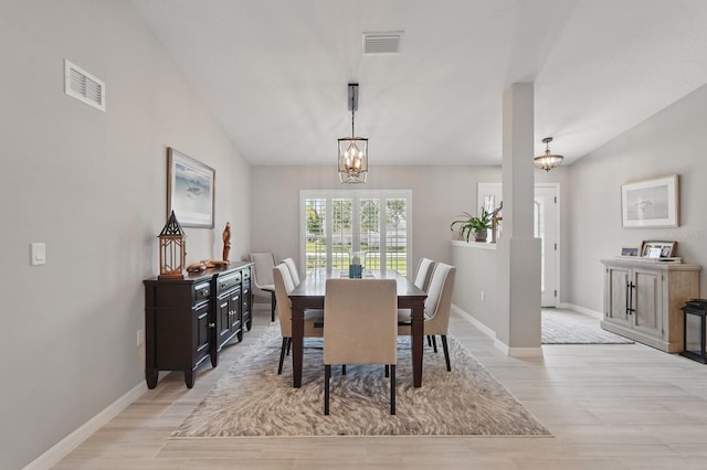 70 Esperanto Dr, Palm Coast, FL 32164 - dining room featuring a chandelier, light wood-type flooring, baseboards, and lofted ceiling