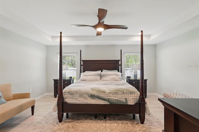 70 Esperanto Dr, Palm Coast, FL 32164 - bedroom featuring light wood-style flooring, baseboards, a ceiling fan, and a tray ceiling