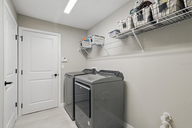 70 Esperanto Dr, Palm Coast, FL 32164 - washroom with separate washer and dryer, baseboards, and light wood-type flooring