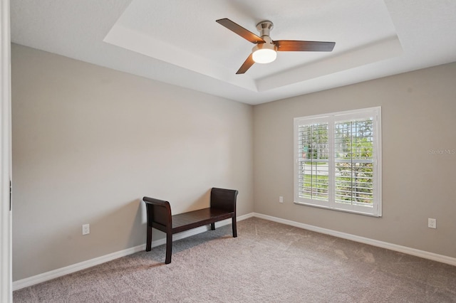 70 Esperanto Dr, Palm Coast, FL 32164 - empty room with a tray ceiling, light carpet, a ceiling fan, and baseboards