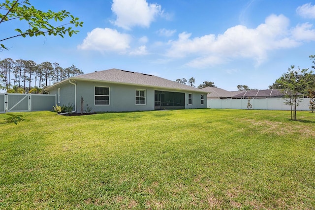 70 Esperanto Dr, Palm Coast, FL 32164 - rear view of house with stucco siding and a gate