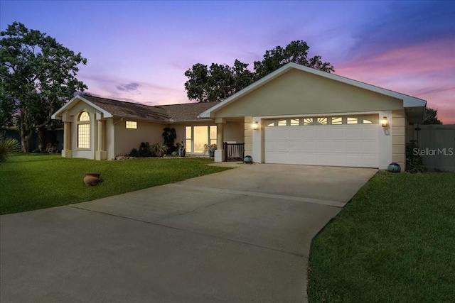16 S Claymont Ct S, Palm Coast, FL 32137 - ranch-style house with driveway, stucco siding, a lawn, and an attached garage