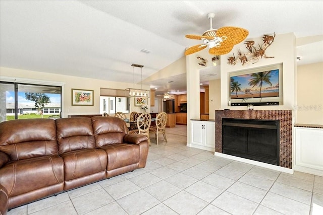 16 S Claymont Ct S, Palm Coast, FL 32137 - living room with light tile patterned floors, ceiling fan, a fireplace, and vaulted ceiling