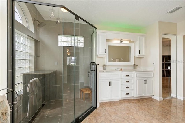 16 S Claymont Ct S, Palm Coast, FL 32137 - full bathroom with double vanity, a shower stall, and a textured ceiling