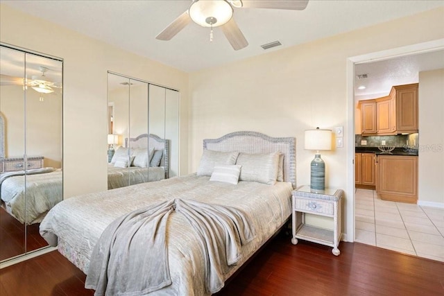 16 S Claymont Ct S, Palm Coast, FL 32137 - bedroom featuring two closets, light wood finished floors, and a ceiling fan