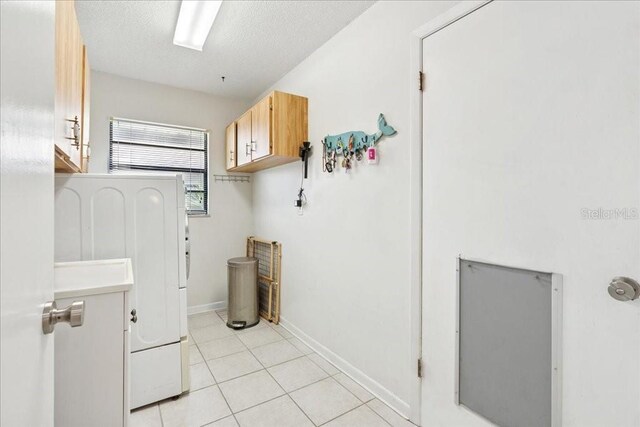 16 S Claymont Ct S, Palm Coast, FL 32137 - laundry area featuring light tile patterned floors, washer / dryer, and a textured ceiling