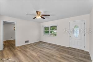 4901 Sailfish Dr, Ponce Inlet, FL 32127 - entrance foyer with wood finished floors and ceiling fan