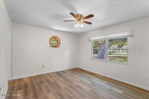 4901 Sailfish Dr, Ponce Inlet, FL 32127 - unfurnished room with wood finished floors, ceiling fan, and baseboards