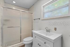 4901 Sailfish Dr, Ponce Inlet, FL 32127 - bathroom featuring vanity, toilet, a stall shower, and recessed lighting