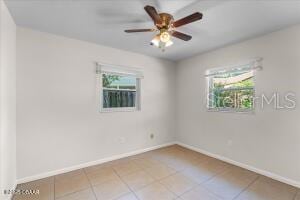 4901 Sailfish Dr, Ponce Inlet, FL 32127 - tiled spare room with healthy amount of natural light, baseboards, and ceiling fan