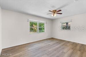 4901 Sailfish Dr, Ponce Inlet, FL 32127 - empty room with wood finished floors and a ceiling fan