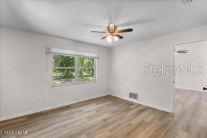 4901 Sailfish Dr, Ponce Inlet, FL 32127 - empty room with wood finished floors, a ceiling fan, and baseboards