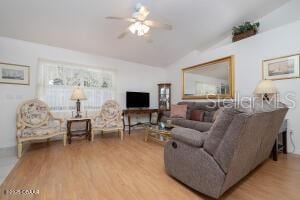 54 Price Ln, Palm Coast, FL 32164 - living area featuring lofted ceiling, wood finished floors, and a ceiling fan