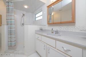 54 Price Ln, Palm Coast, FL 32164 - full bathroom with a shower with curtain and vanity