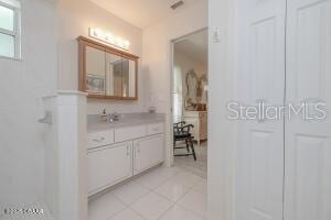 54 Price Ln, Palm Coast, FL 32164 - full bathroom featuring vanity, tile patterned flooring, and a shower