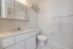 54 Price Ln, Palm Coast, FL 32164 - full bath with vanity, toilet, tile patterned floors, and baseboards