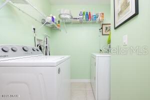 54 Price Ln, Palm Coast, FL 32164 - washroom featuring separate washer and dryer and light tile patterned flooring
