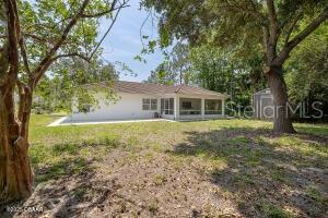 54 Price Ln, Palm Coast, FL 32164 - rear view of property with a yard