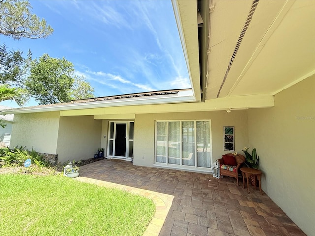 9 Cotton Ct, Palm Coast, FL 32137 - back of house with stucco siding, a patio, and a yard