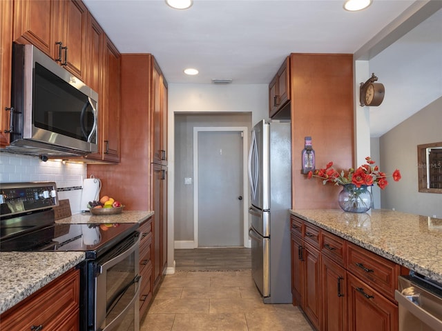 9 Cotton Ct, Palm Coast, FL 32137 - kitchen with appliances with stainless steel finishes, backsplash, recessed lighting, light stone counters, and light tile patterned floors