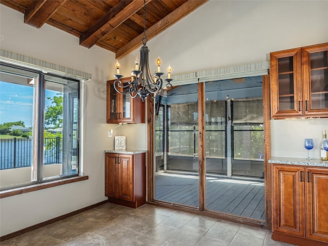 9 Cotton Ct, Palm Coast, FL 32137 - unfurnished dining area featuring wood ceiling, a chandelier, and baseboards