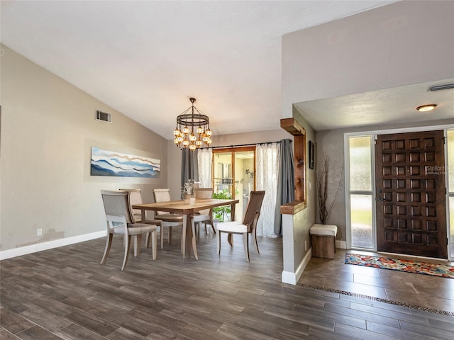9 Cotton Ct, Palm Coast, FL 32137 - dining area featuring dark wood finished floors, baseboards, a chandelier, and lofted ceiling