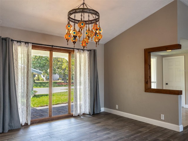 9 Cotton Ct, Palm Coast, FL 32137 - unfurnished dining area featuring dark wood-style flooring, baseboards, and lofted ceiling