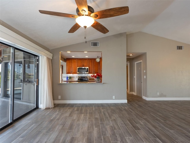 9 Cotton Ct, Palm Coast, FL 32137 - unfurnished living room with vaulted ceiling, a ceiling fan, dark wood-style flooring, and baseboards