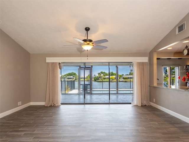 9 Cotton Ct, Palm Coast, FL 32137 - spare room featuring baseboards, dark wood-style floors, ceiling fan, and plenty of natural light