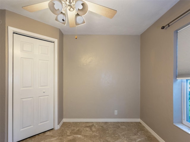 9 Cotton Ct, Palm Coast, FL 32137 - unfurnished bedroom with a closet, ceiling fan, and baseboards