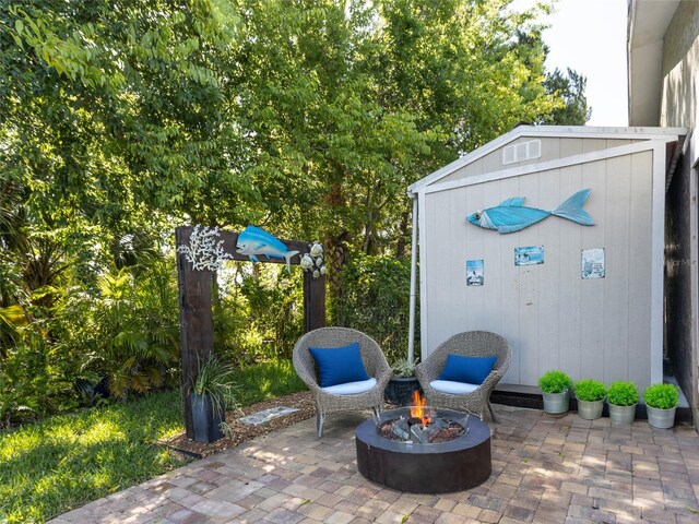 9 Cotton Ct, Palm Coast, FL 32137 - view of patio / terrace with an outdoor fire pit and an outbuilding