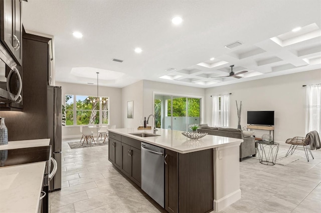80 N Lakewalk Dr, Palm Coast, FL 32137 - kitchen with stainless steel appliances, a sink, recessed lighting, dark brown cabinets, and healthy amount of natural light