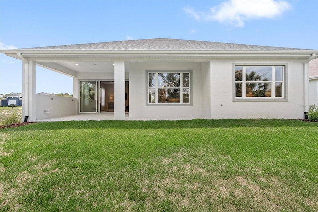 80 N Lakewalk Dr, Palm Coast, FL 32137 - rear view of property featuring a patio area, a yard, a shingled roof, and stucco siding