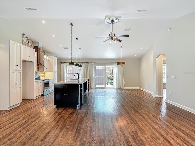 14 Zollinger Pl, Palm Coast, FL 32164 - kitchen with stainless steel range with electric stovetop, arched walkways, a ceiling fan, light countertops, and dark wood-style flooring