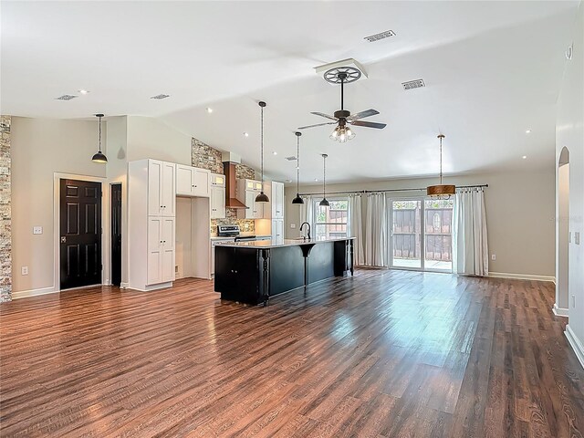 14 Zollinger Pl, Palm Coast, FL 32164 - kitchen with open floor plan, a ceiling fan, wall chimney range hood, white cabinets, and dark wood finished floors