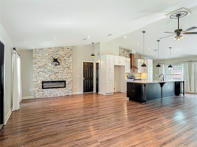 14 Zollinger Pl, Palm Coast, FL 32164 - kitchen with open floor plan, wood finished floors, light countertops, ceiling fan, and high vaulted ceiling