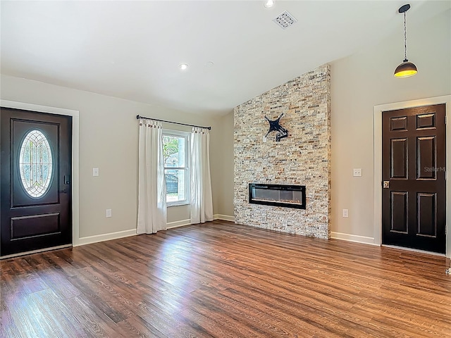 14 Zollinger Pl, Palm Coast, FL 32164 - foyer entrance with wood finished floors, lofted ceiling, a stone fireplace, baseboards, and recessed lighting