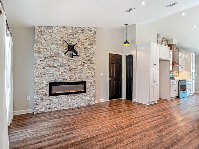 14 Zollinger Pl, Palm Coast, FL 32164 - unfurnished living room featuring dark wood-style floors, a stone fireplace, baseboards, and high vaulted ceiling