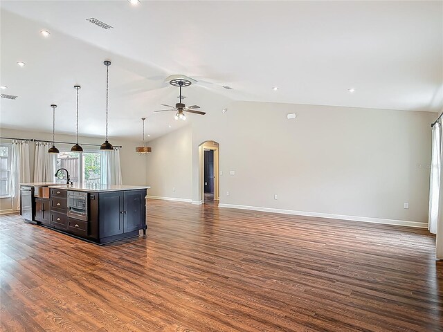 14 Zollinger Pl, Palm Coast, FL 32164 - kitchen featuring open floor plan, wood finished floors, arched walkways, light countertops, and a ceiling fan