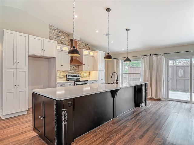 14 Zollinger Pl, Palm Coast, FL 32164 - kitchen featuring stainless steel electric range oven, vaulted ceiling, wood finished floors, tasteful backsplash, and a large island with sink