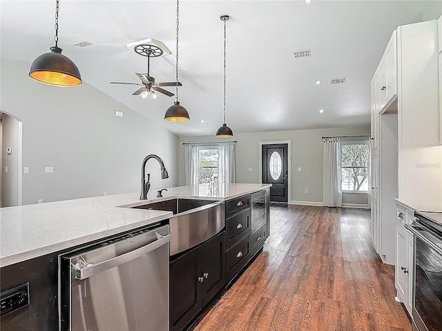 14 Zollinger Pl, Palm Coast, FL 32164 - kitchen featuring stainless steel dishwasher, dark cabinetry, a sink, white cabinetry, and wood finished floors